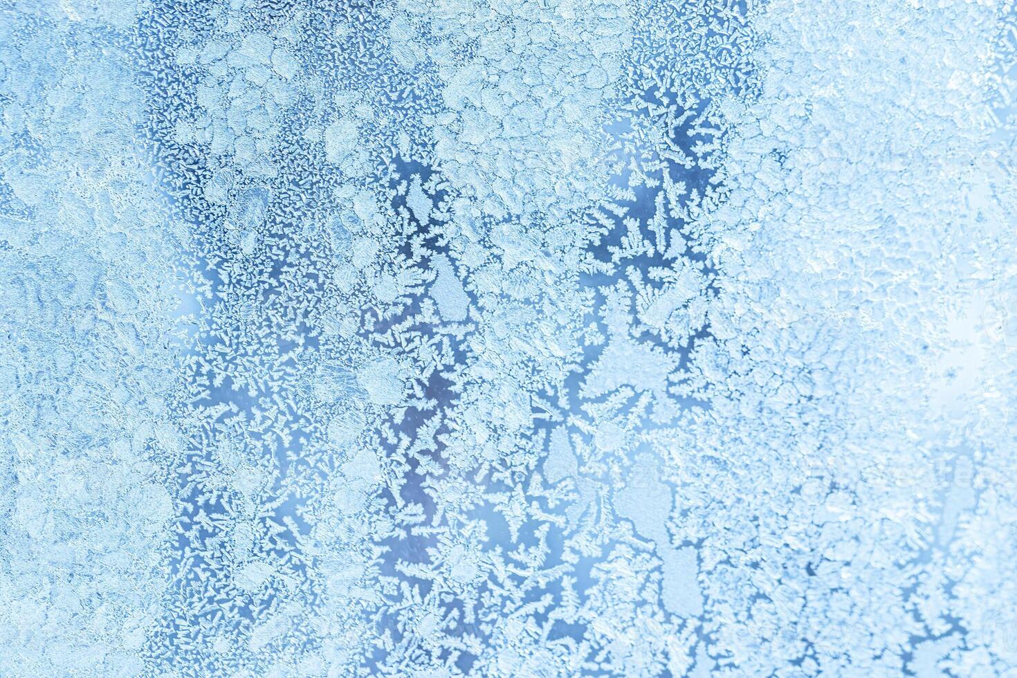The texture of the glass covered with frost in winter in cold weather. Abstract background. photo
