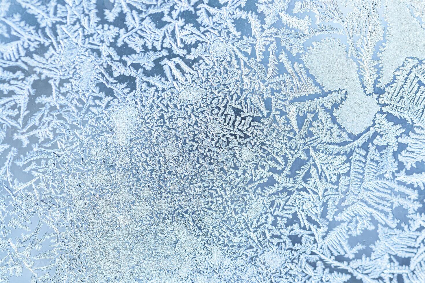 The texture of the glass covered with frost in winter in cold weather. Abstract background. photo