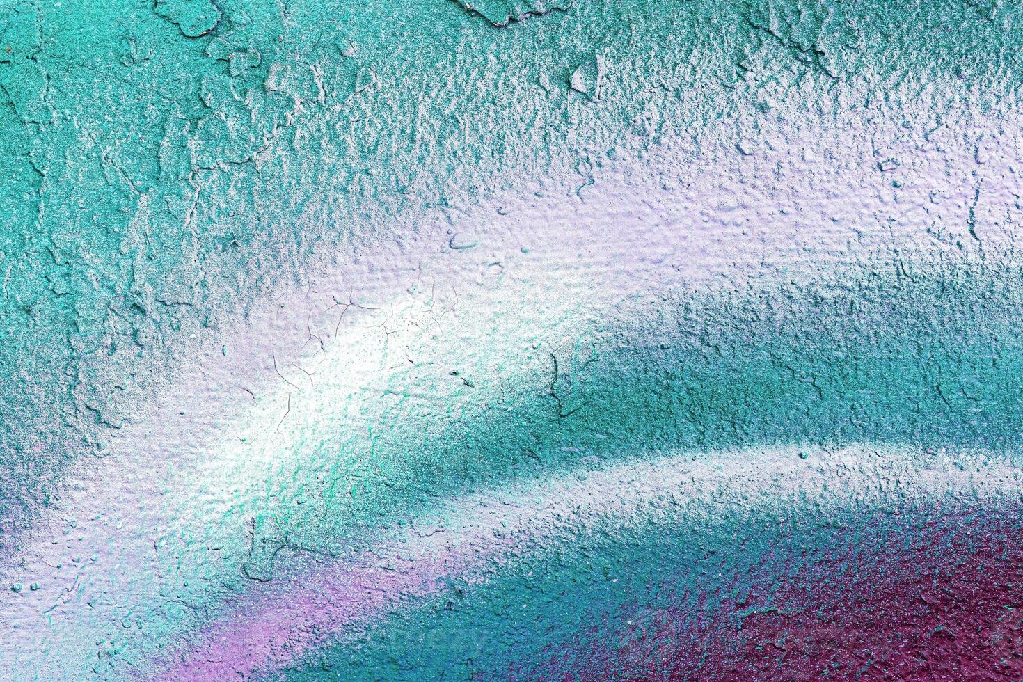 A fragment of colorful graffiti painted on a wall. Abstract urban background. photo