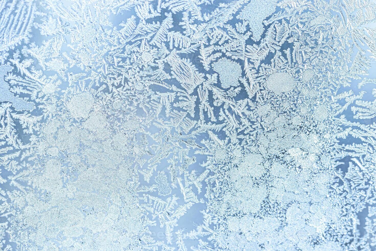 The texture of the glass covered with frost in winter in cold weather. Abstract background. photo