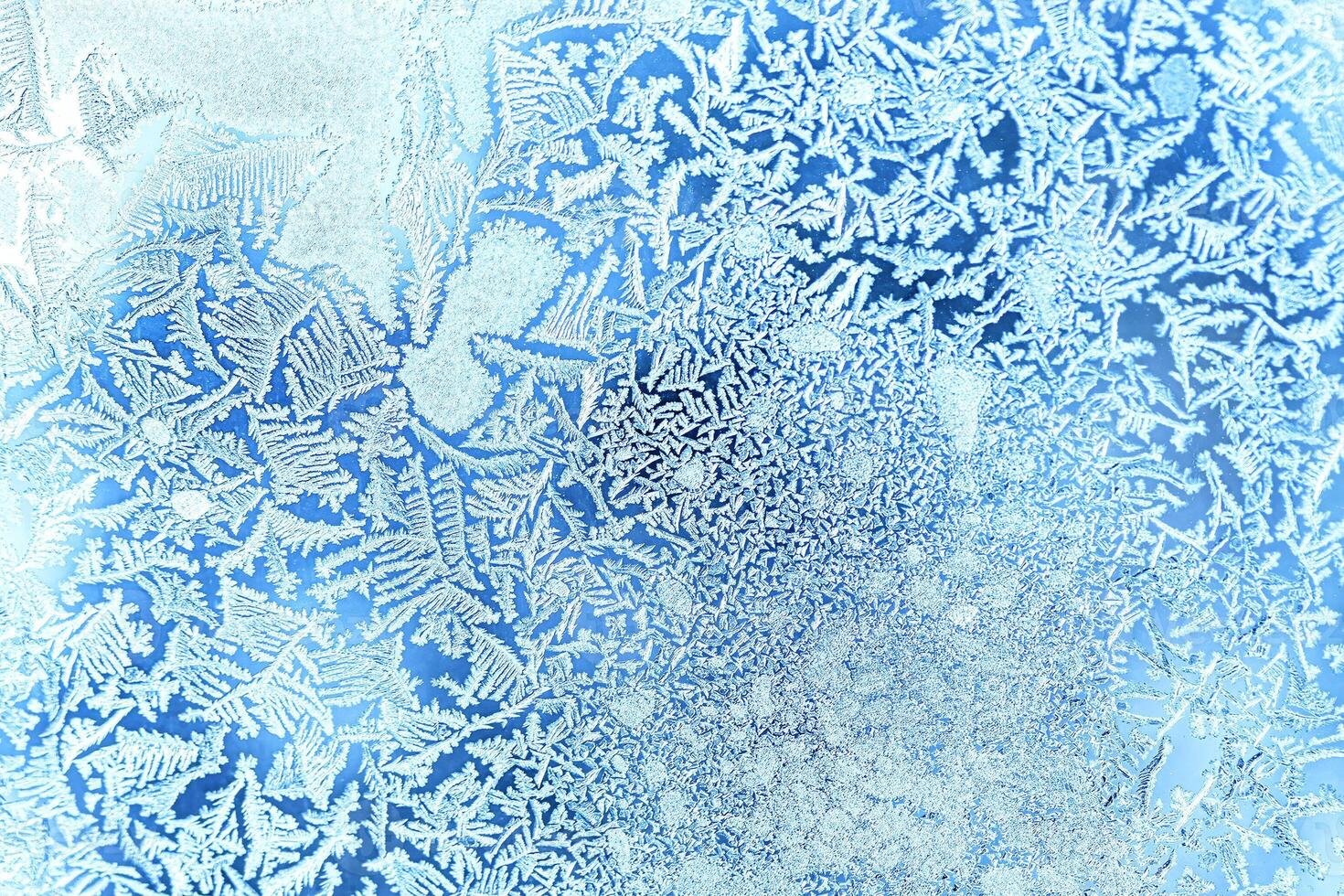 The texture of the glass covered with frost in winter in cold weather. Abstract background. photo