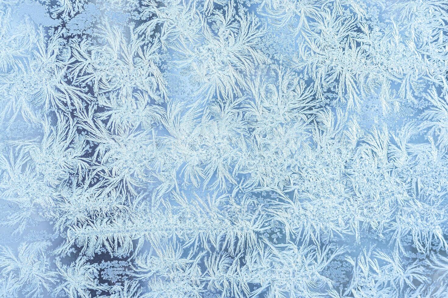 The texture of the glass covered with frost in winter in cold weather. Abstract background. photo