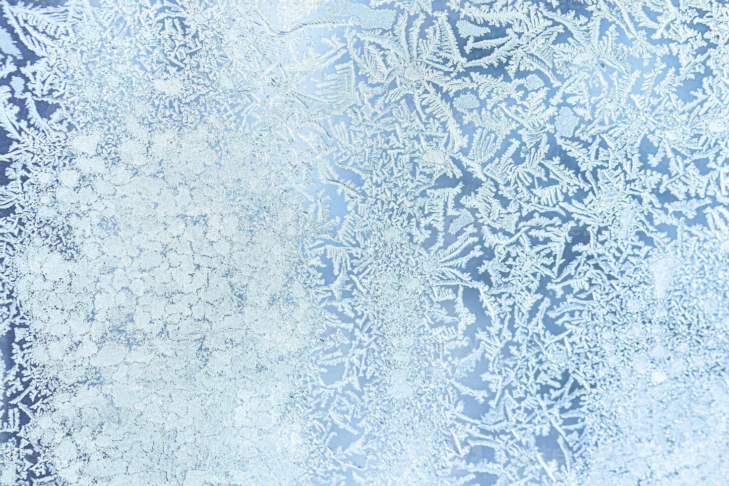 The texture of the glass covered with frost in winter in cold weather. Abstract background. photo