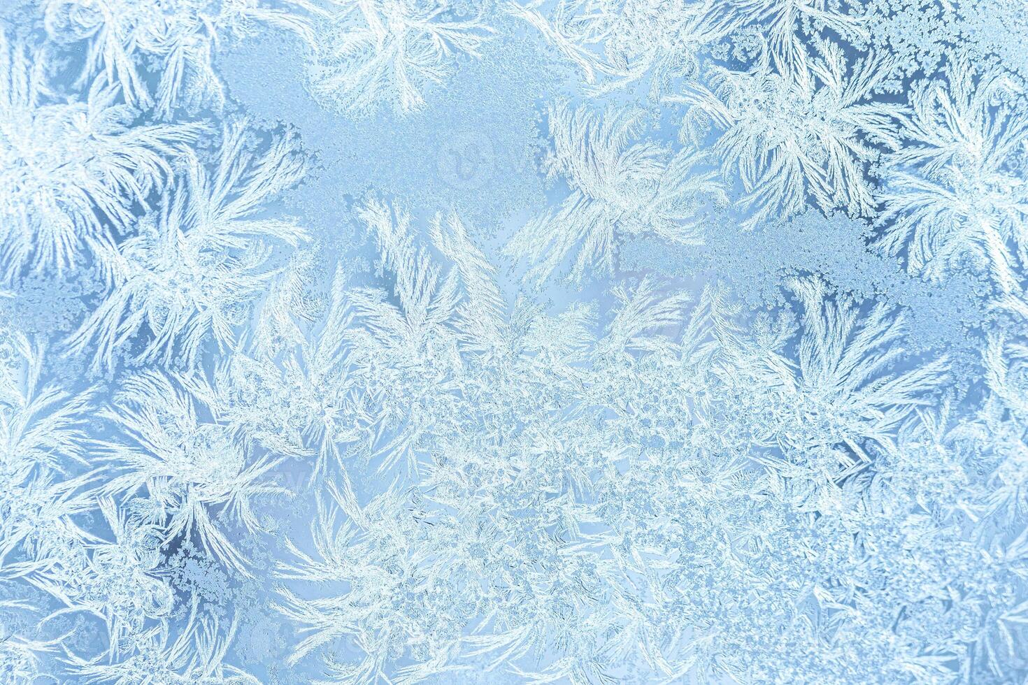 The texture of the glass covered with frost in winter in cold weather. Abstract background. photo