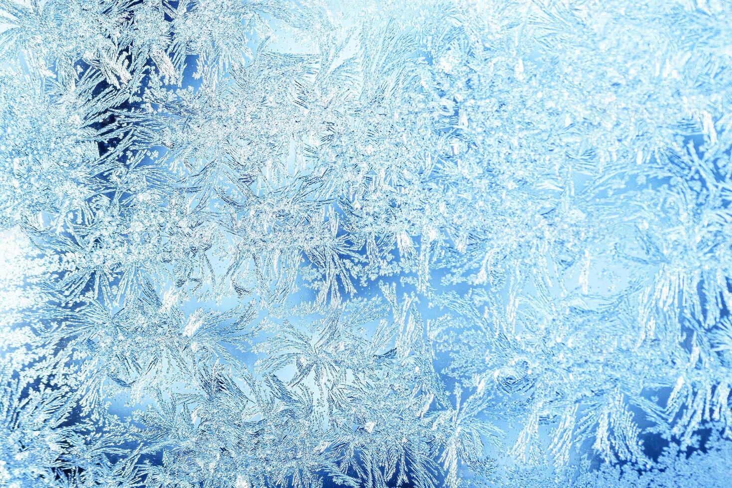 The texture of the glass covered with frost in winter in cold weather. Abstract background. photo