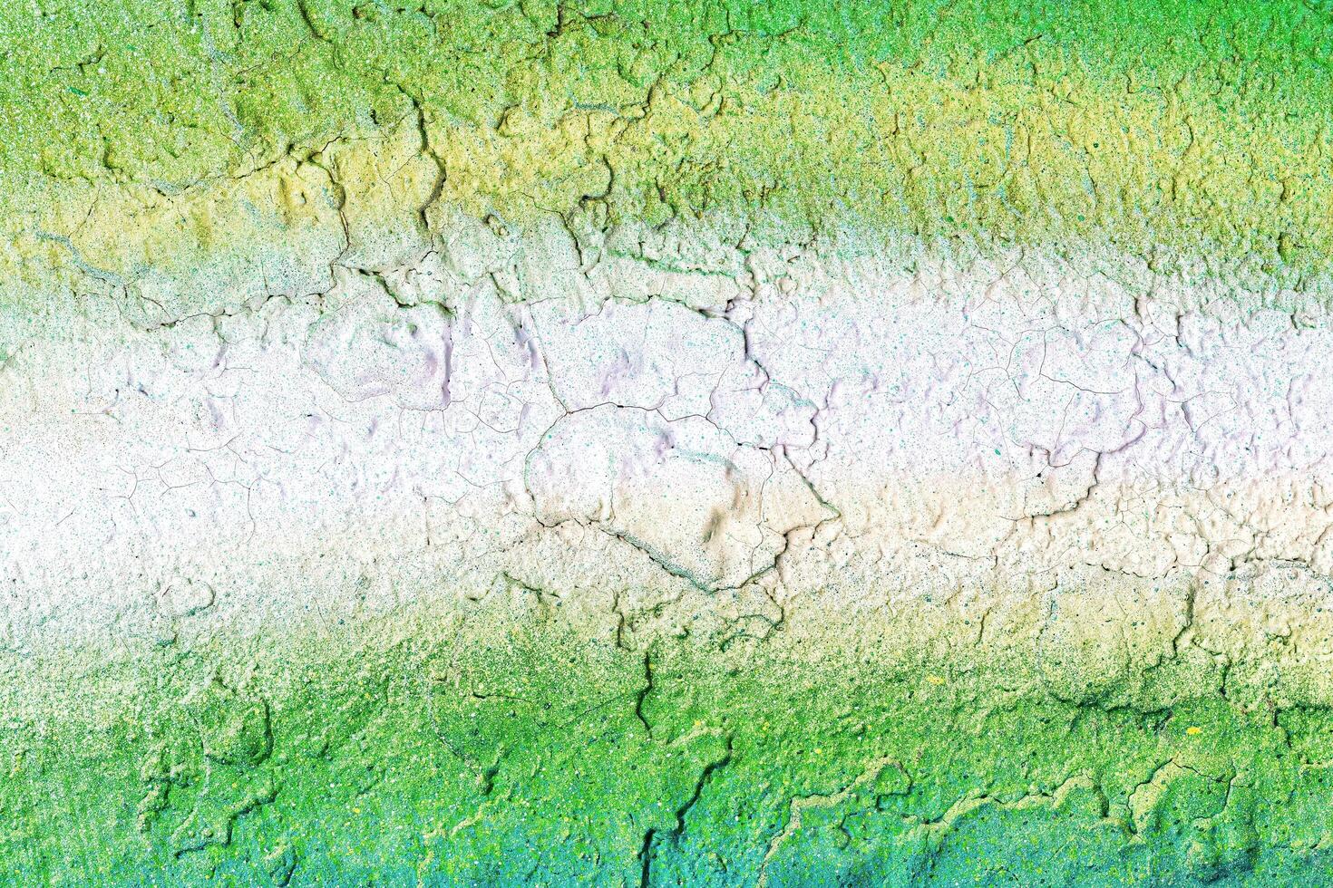 A fragment of colorful graffiti painted on a wall. Abstract urban background. photo