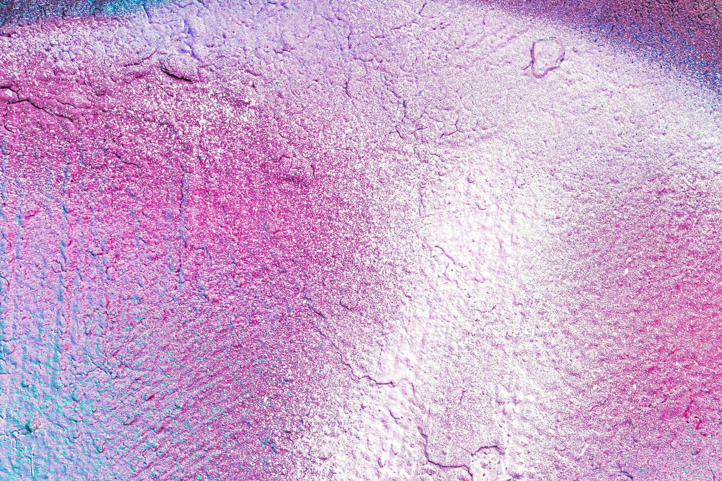 A fragment of colorful graffiti painted on a wall. Abstract urban background. photo