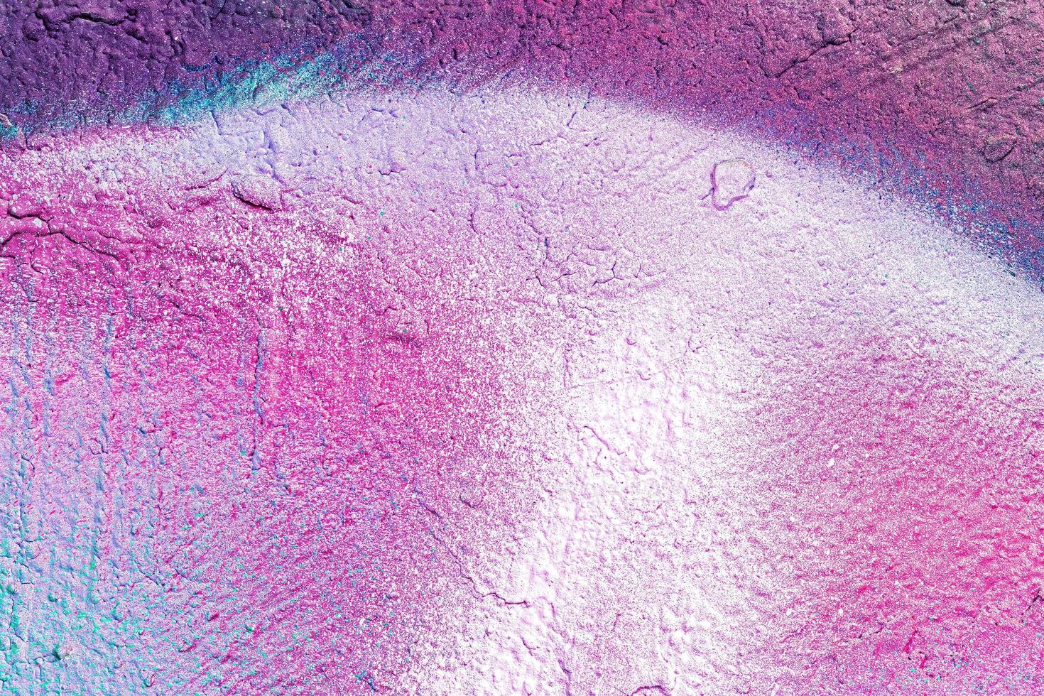 A fragment of colorful graffiti painted on a wall. Abstract urban background. photo