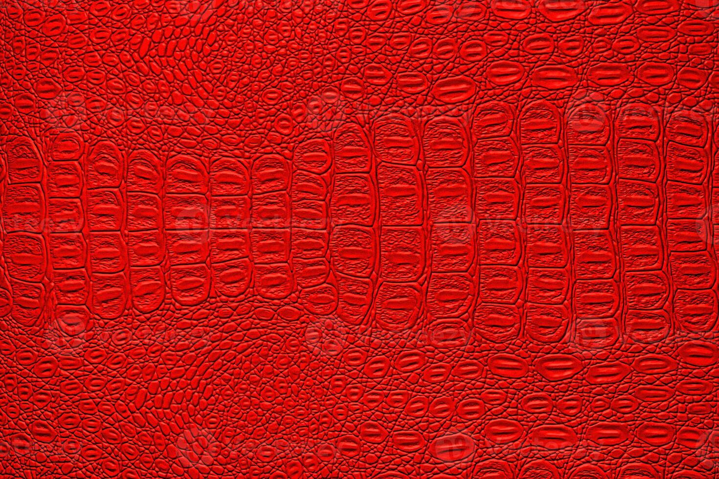 Red crocodile leather texture. Abstract backdrop for design. photo