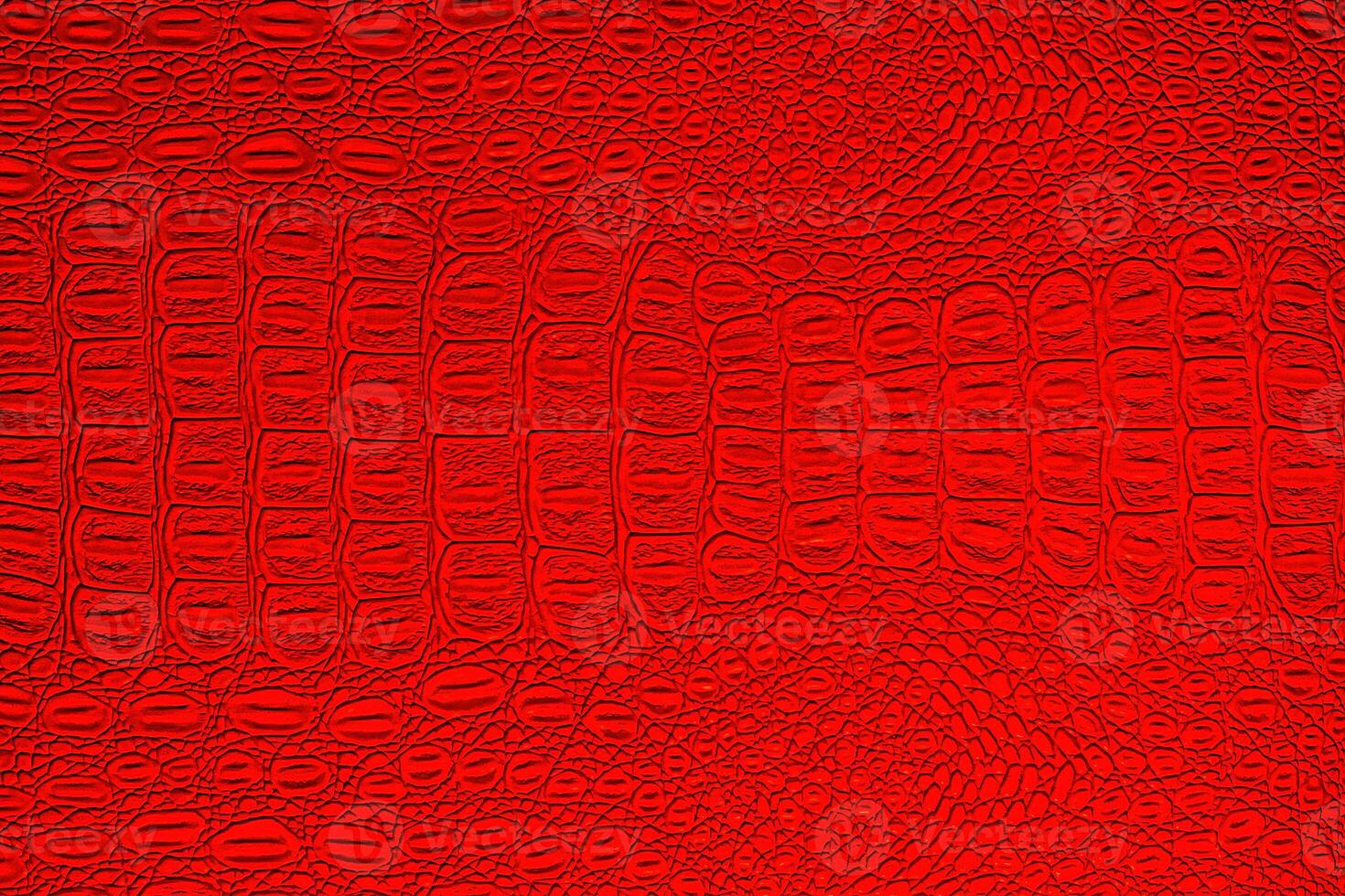 Red crocodile leather texture. Abstract backdrop for design. photo