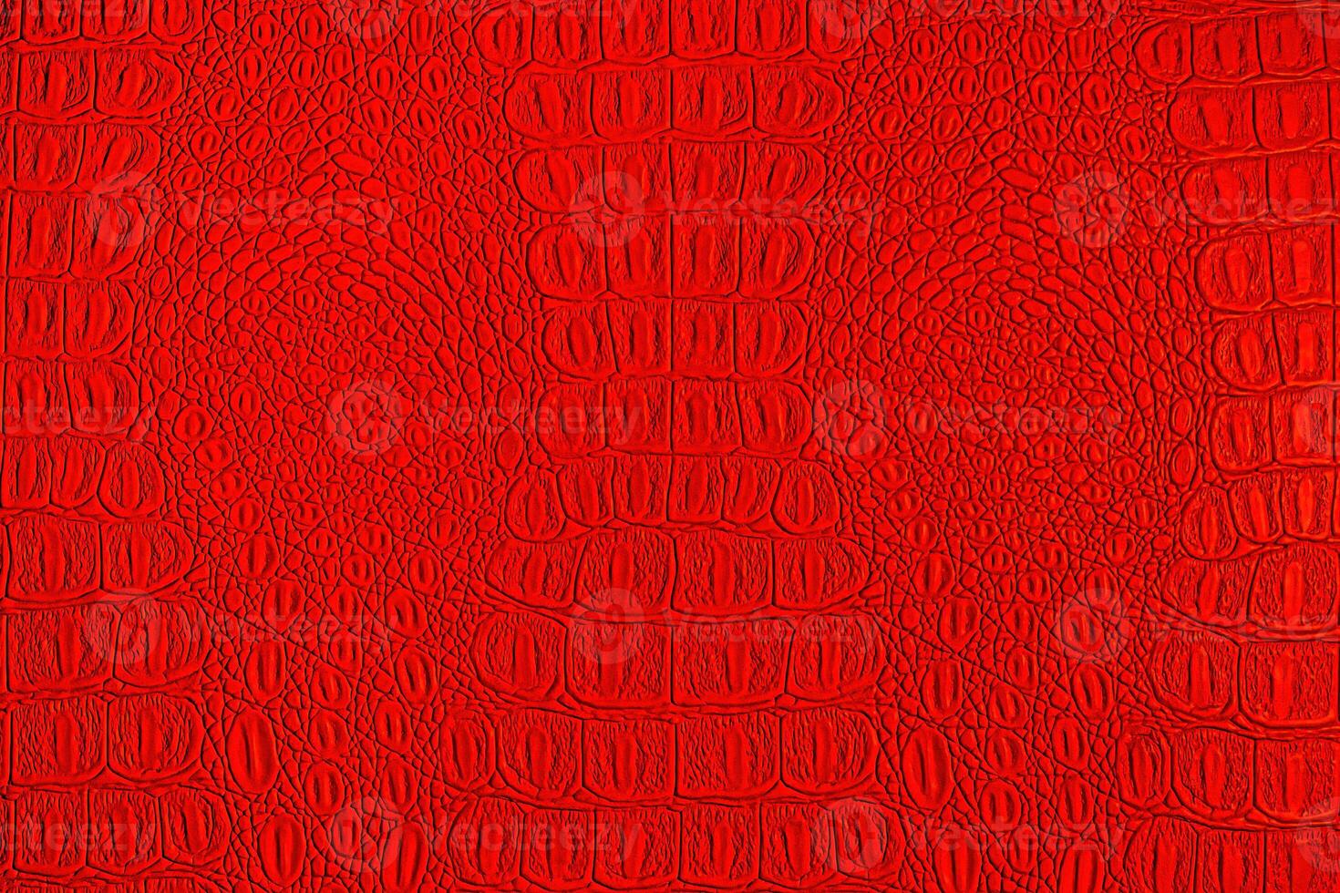 Red crocodile leather texture. Abstract backdrop for design. photo
