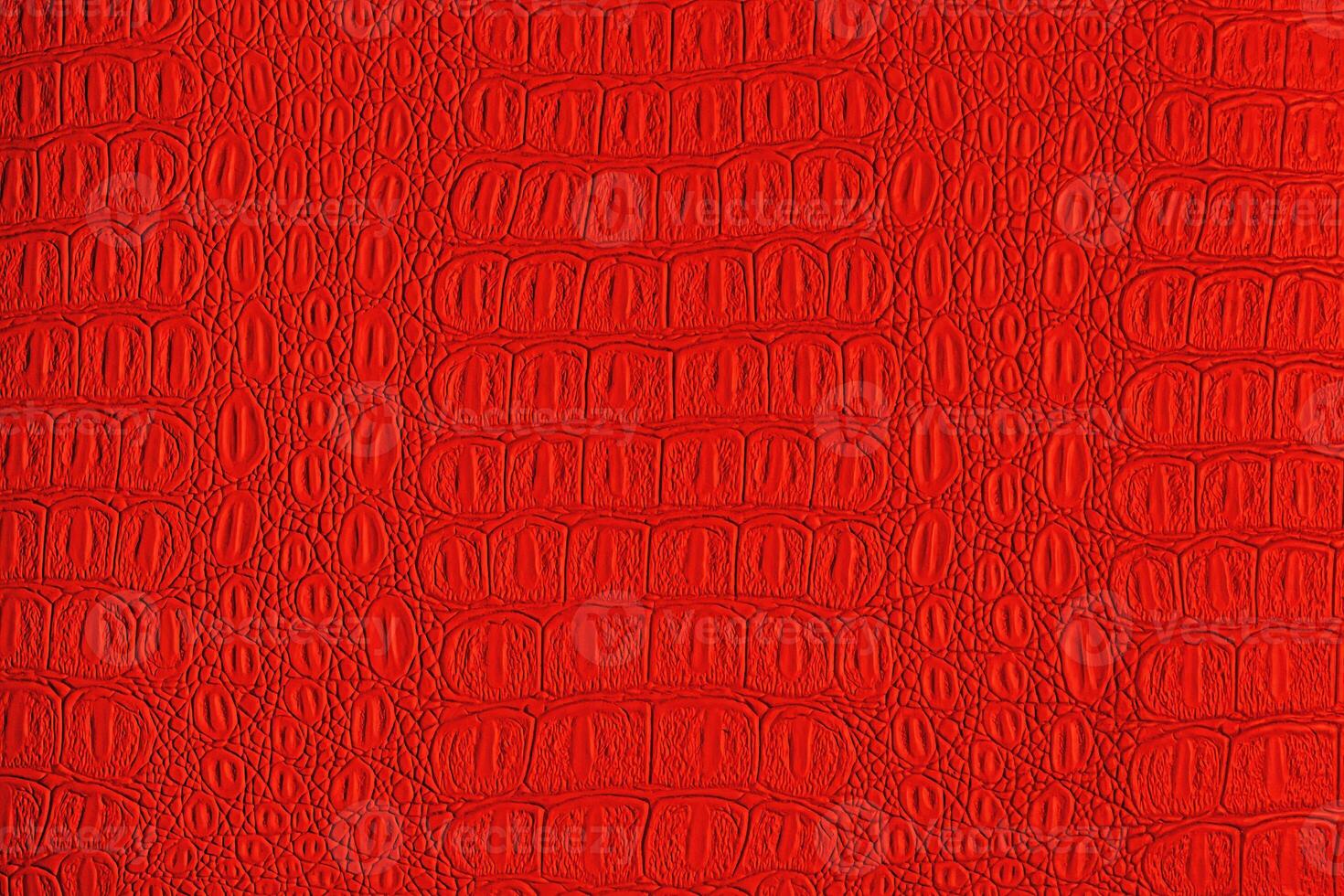 Red crocodile leather texture. Abstract backdrop for design. photo
