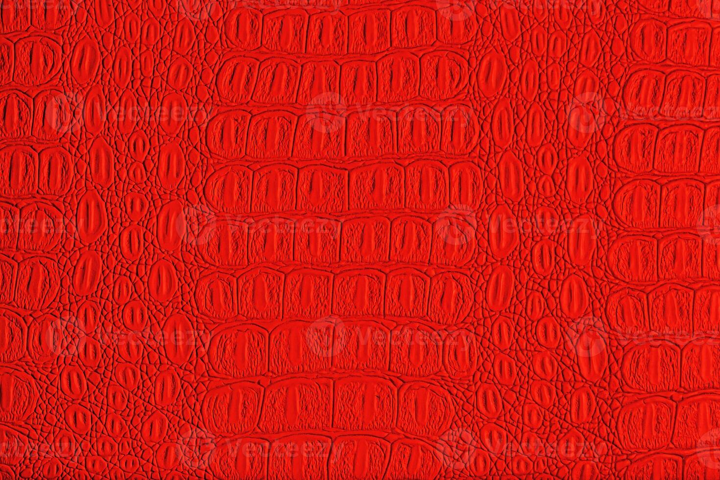 Red crocodile leather texture. Abstract backdrop for design. photo