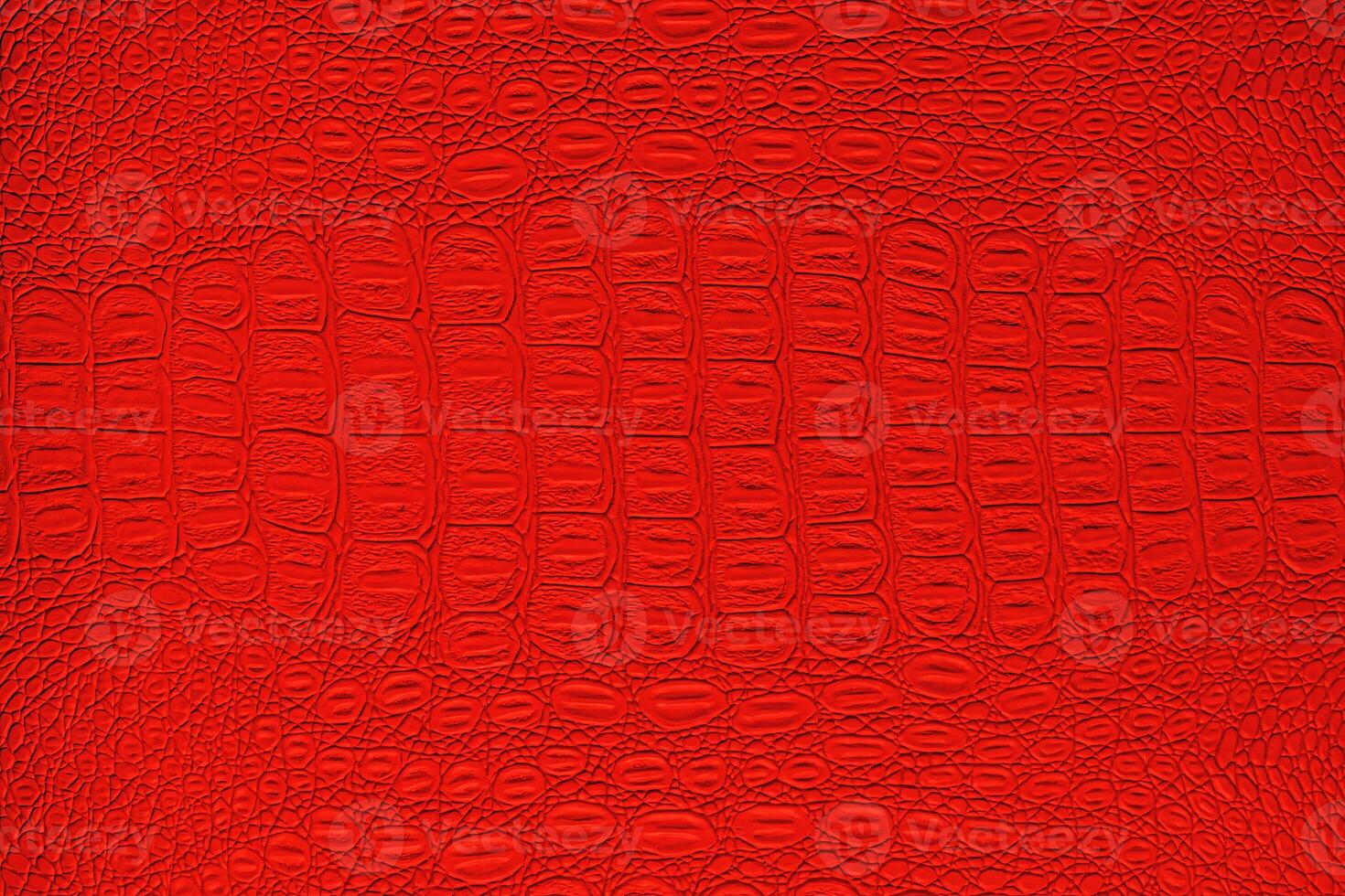 Red crocodile leather texture. Abstract backdrop for design. photo