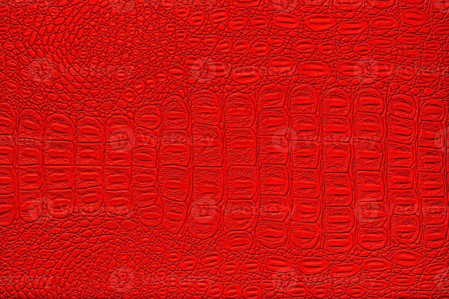 Red crocodile leather texture. Abstract backdrop for design. photo