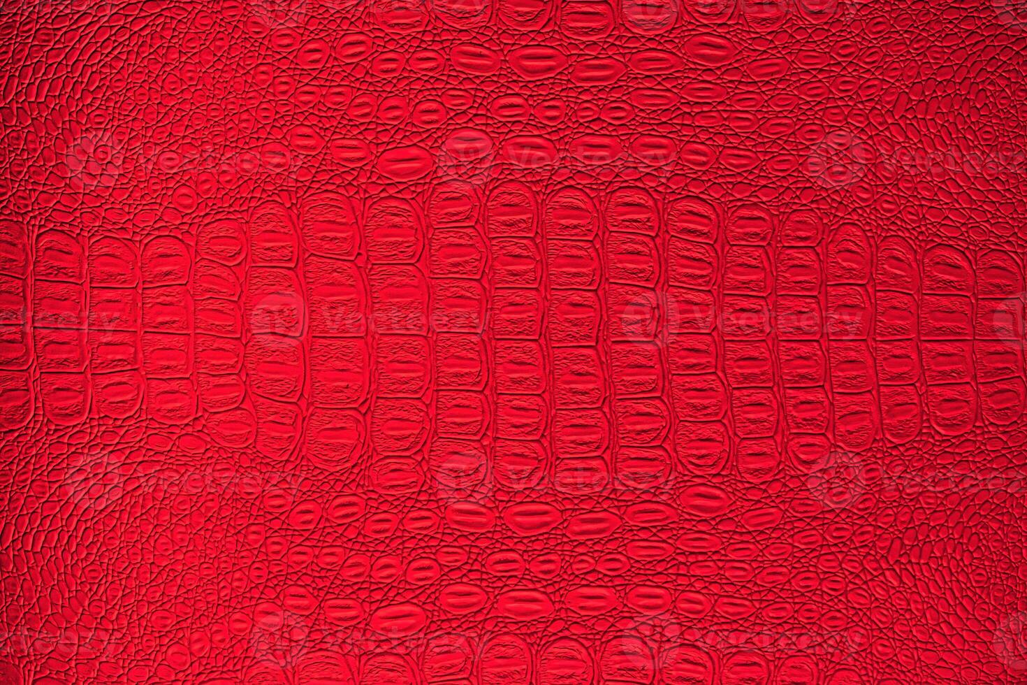 Red crocodile leather texture. Abstract backdrop for design. photo