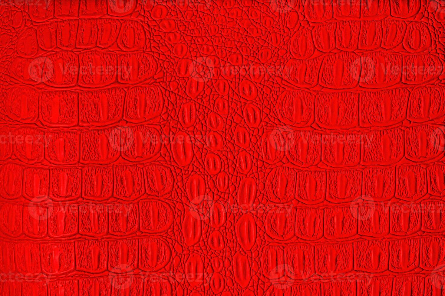 Red crocodile leather texture. Abstract backdrop for design. photo