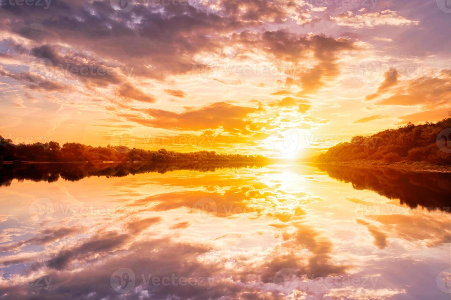 Sunset on the river at summer evening with clouds and trees. Water reflection of a sky. photo