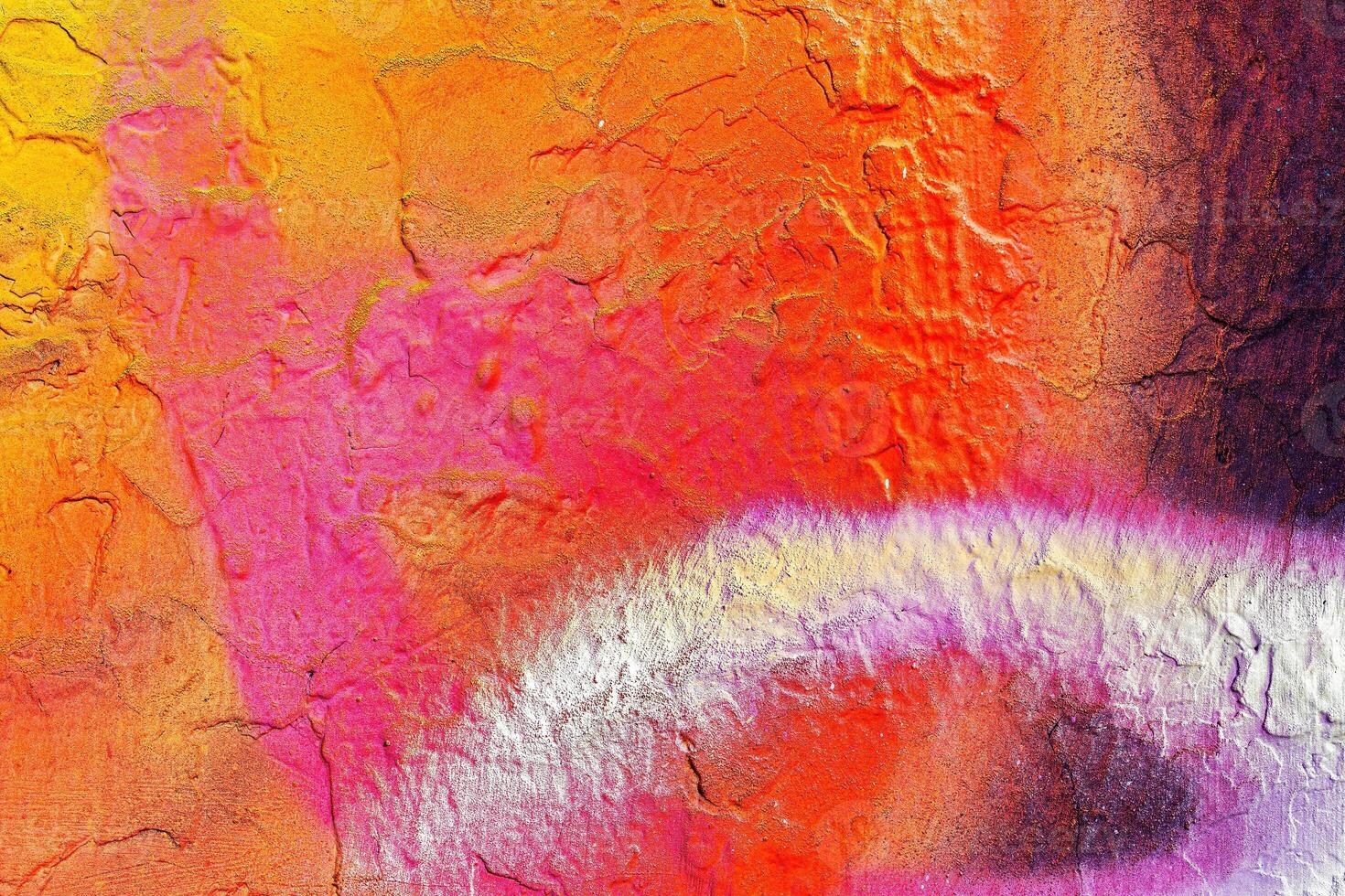 A fragment of colorful graffiti painted on a wall. Abstract urban background. photo