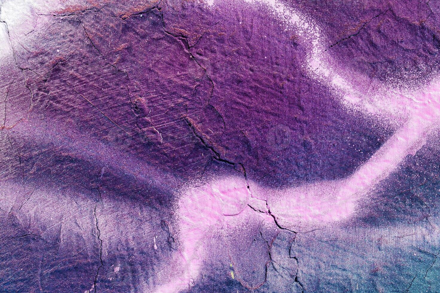 A fragment of colorful graffiti painted on a wall. Abstract urban background. photo