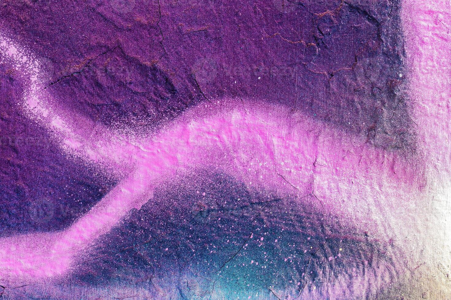 A fragment of colorful graffiti painted on a wall. Abstract urban background. photo