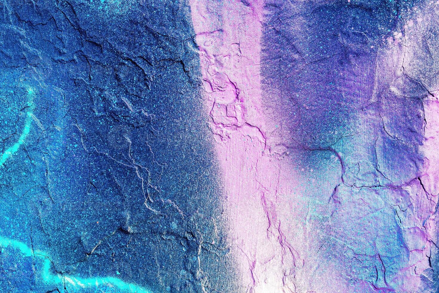 A fragment of colorful graffiti painted on a wall. Abstract urban background. photo