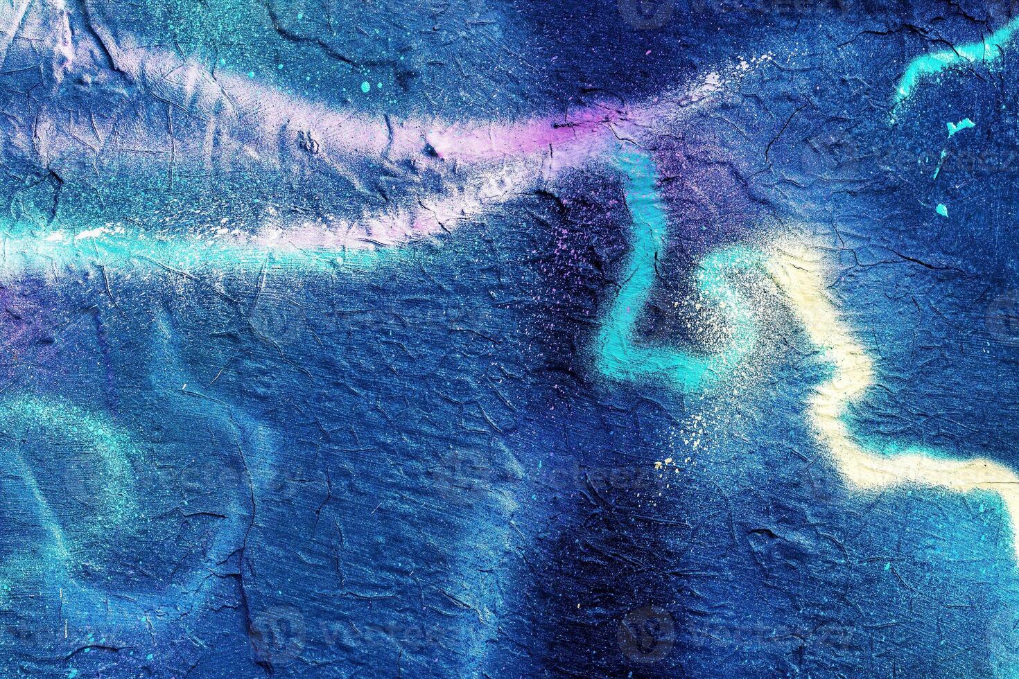 A fragment of colorful graffiti painted on a wall. Abstract urban background. photo