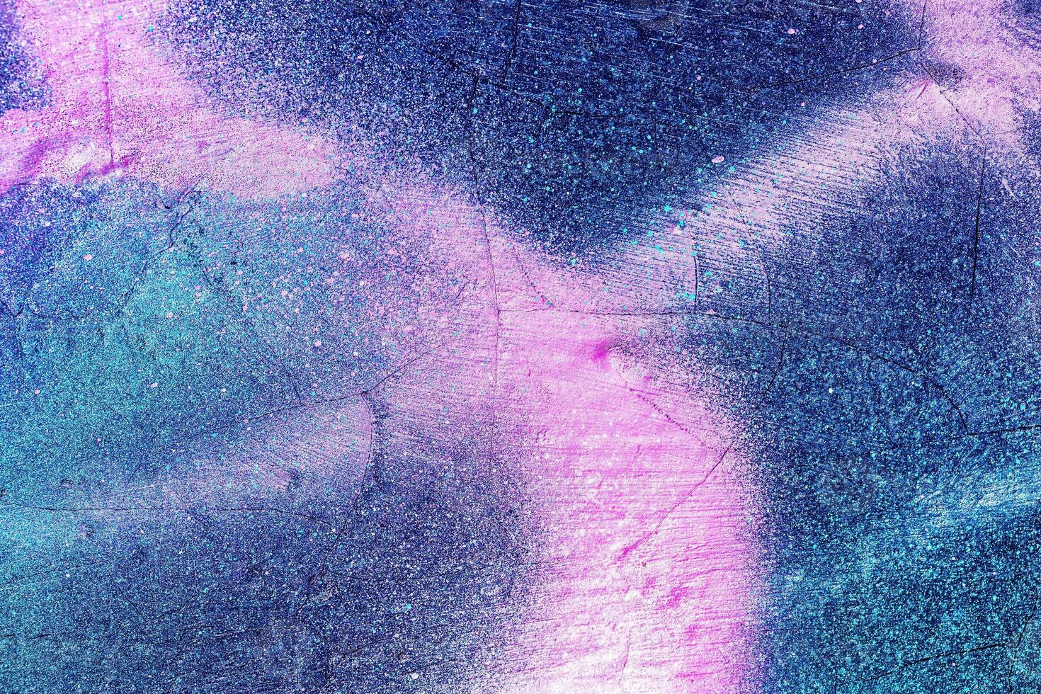 A fragment of colorful graffiti painted on a wall. Abstract urban background. photo