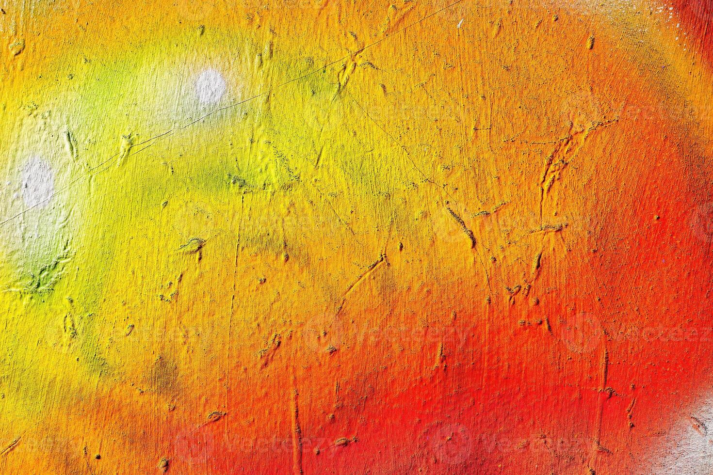 A fragment of colorful graffiti painted on a wall. Abstract urban background. photo