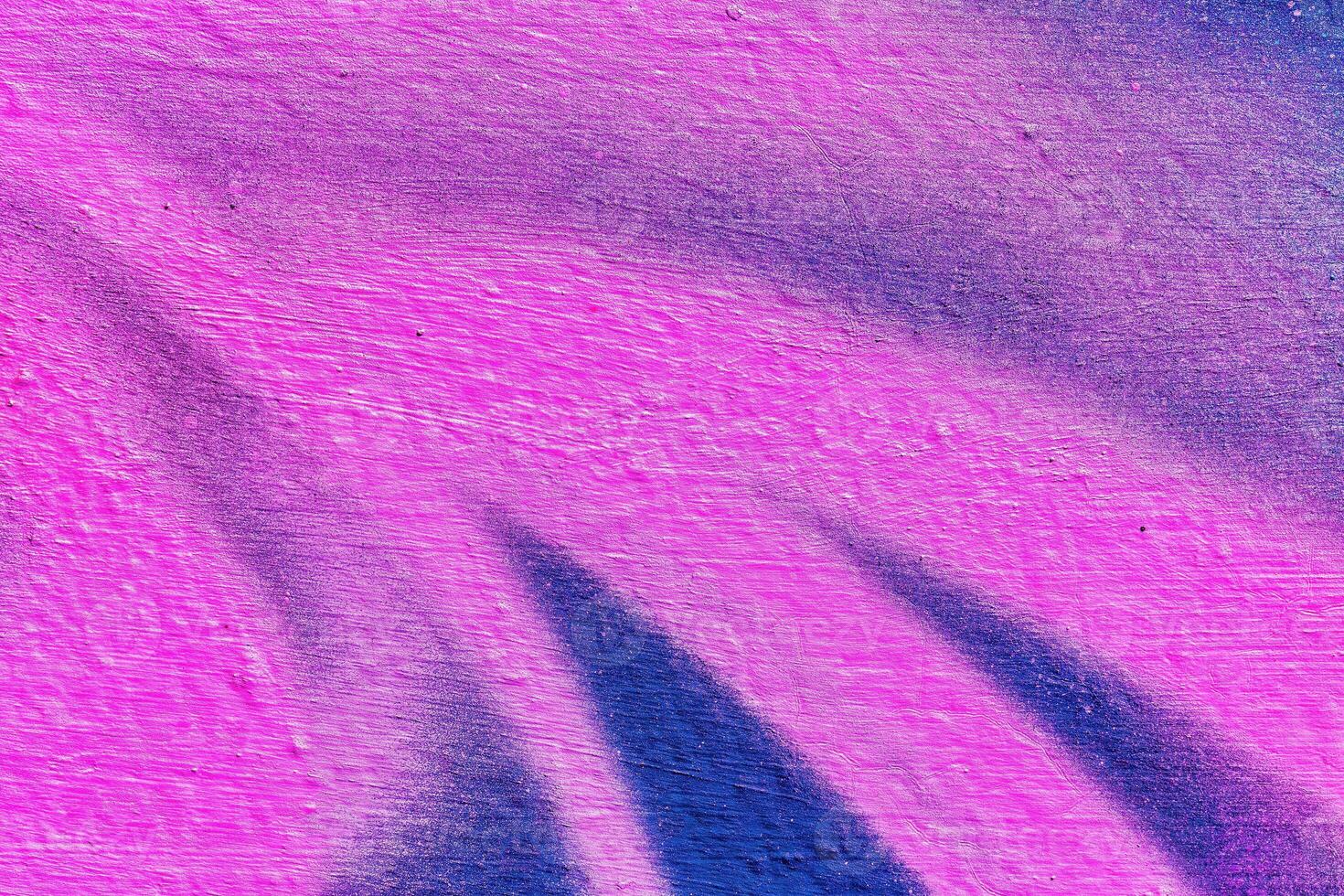 A fragment of colorful graffiti painted on a wall. Abstract urban background. photo