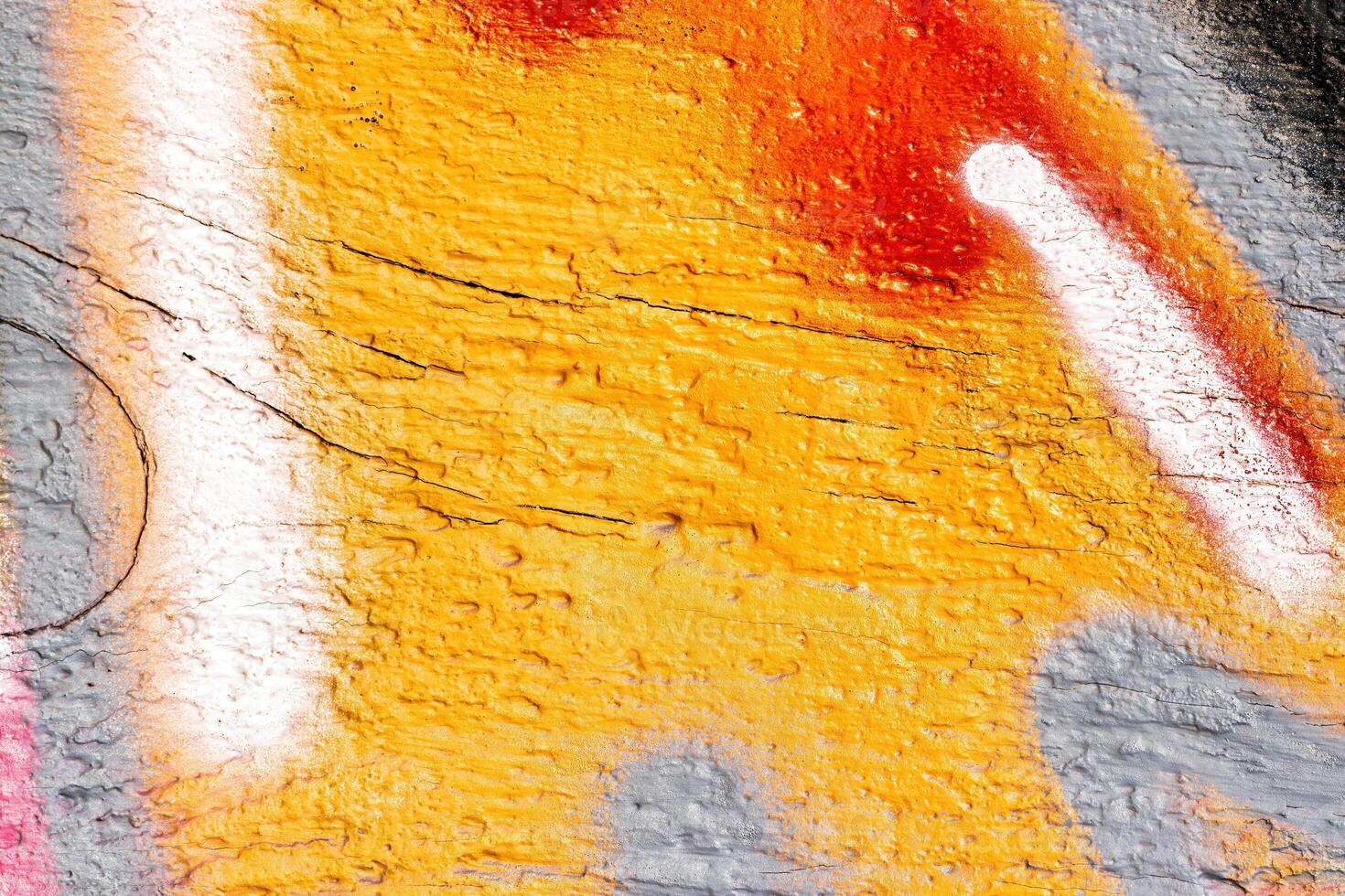 A fragment of colorful graffiti painted on a wall. Abstract urban background. photo