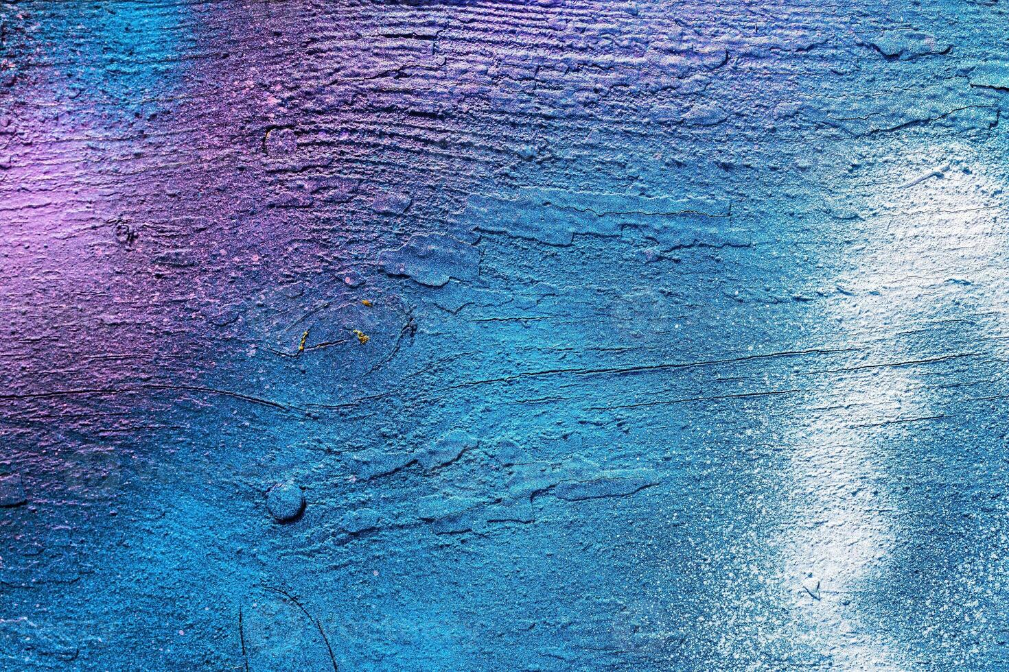 A fragment of colorful graffiti painted on a wall. Abstract urban background. photo