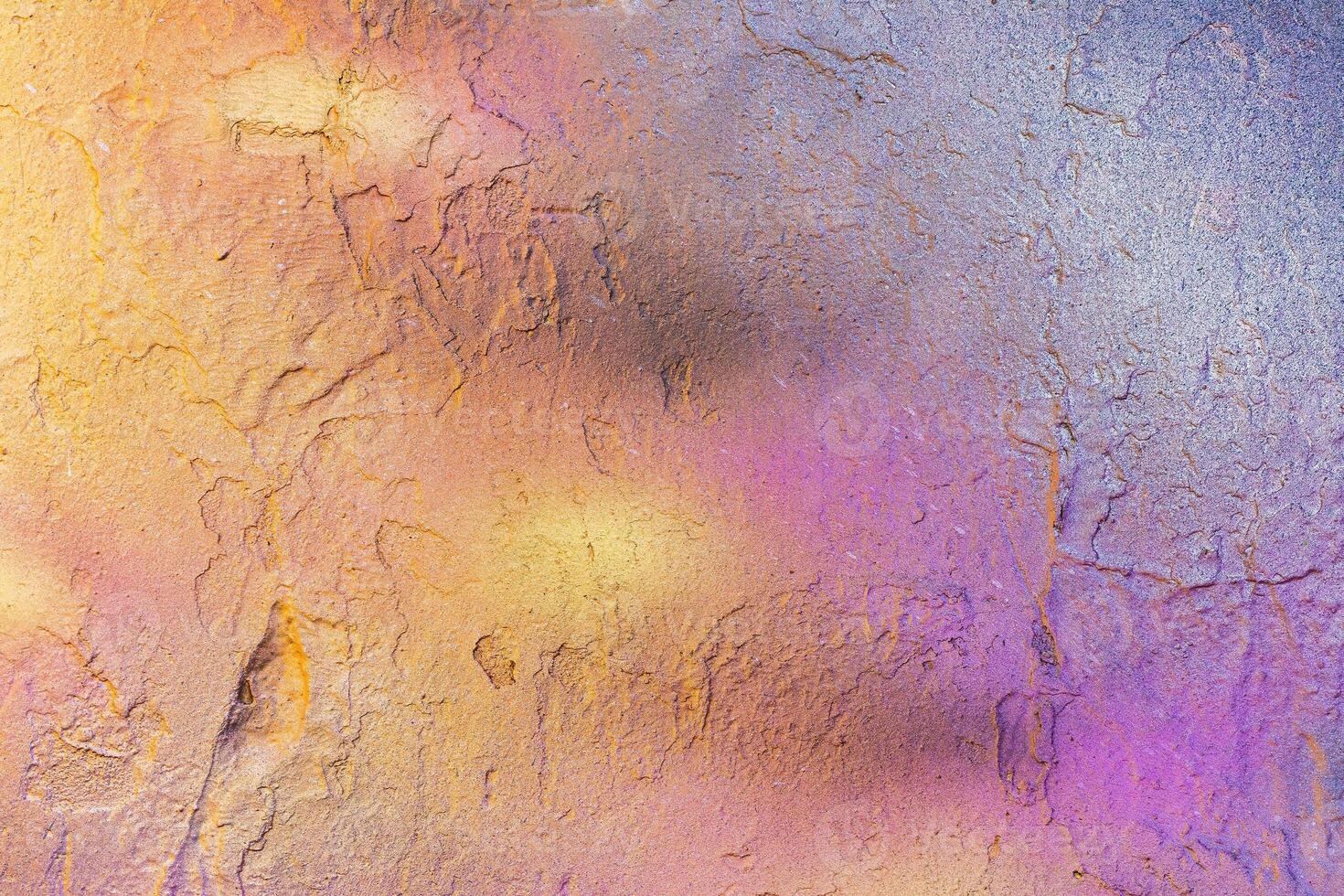 A fragment of colorful graffiti painted on a wall. Abstract urban background. photo