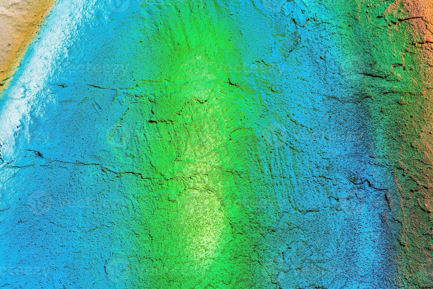A fragment of colorful graffiti painted on a wall. Abstract urban background. photo