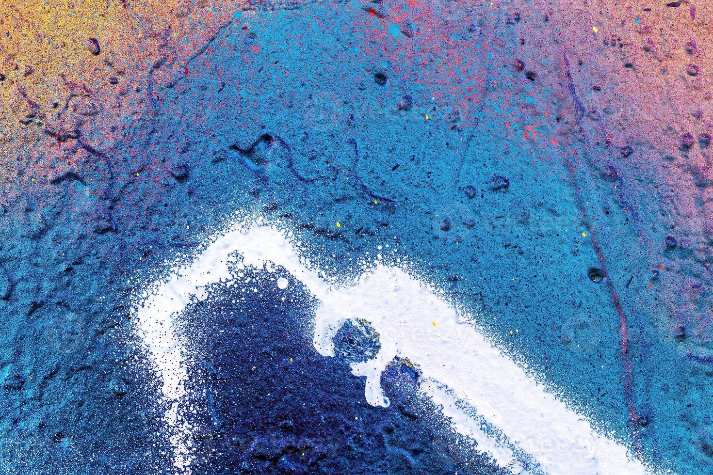 A fragment of colorful graffiti painted on a wall. Abstract urban background. photo