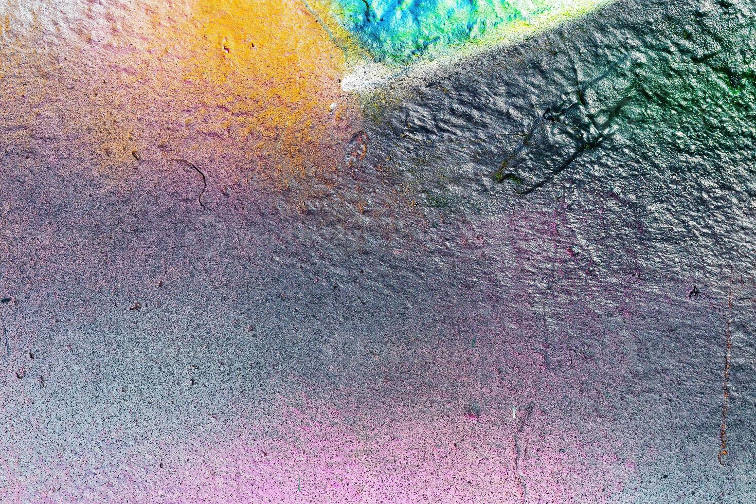 A fragment of colorful graffiti painted on a wall. Abstract urban background. photo