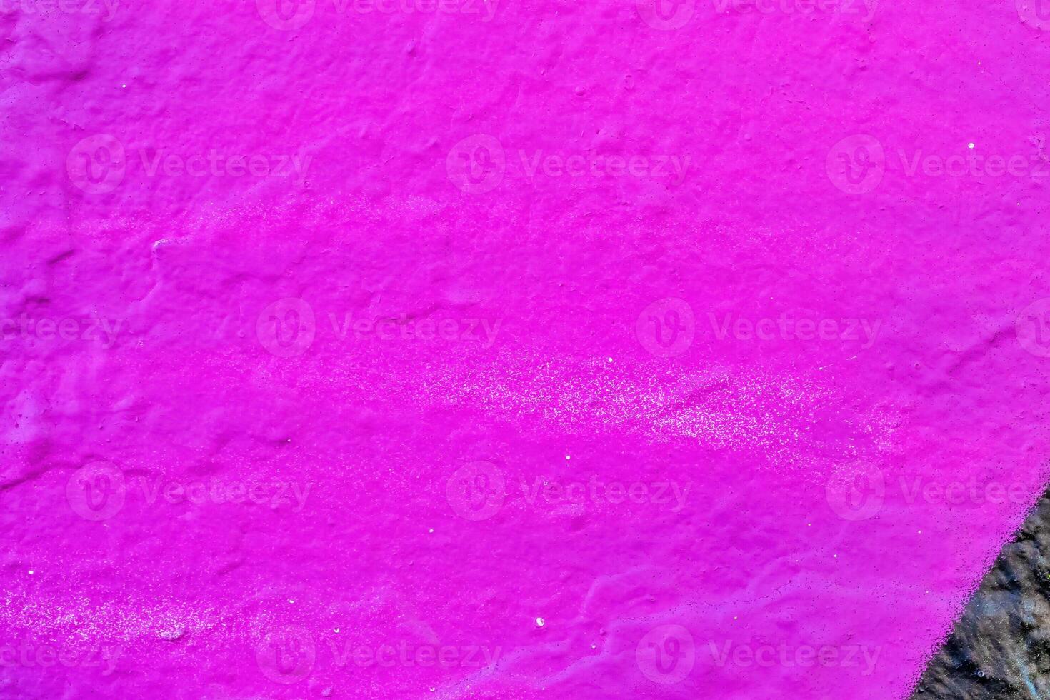 A fragment of colorful graffiti painted on a wall. Abstract urban background. photo
