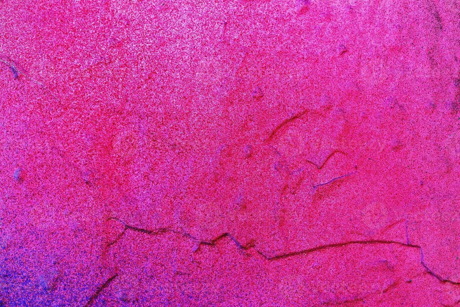 A fragment of colorful graffiti painted on a wall. Abstract urban background. photo
