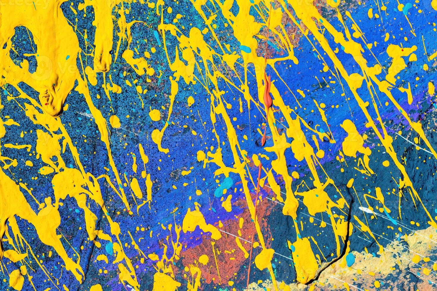 A fragment of colorful graffiti painted on a wall. Abstract urban background. photo