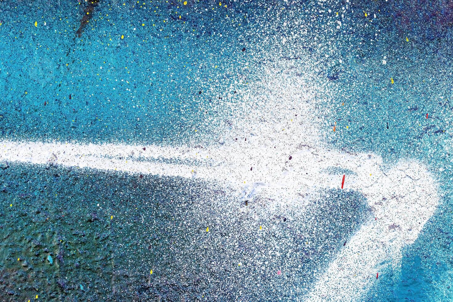 A fragment of colorful graffiti painted on a wall. Abstract urban background. photo