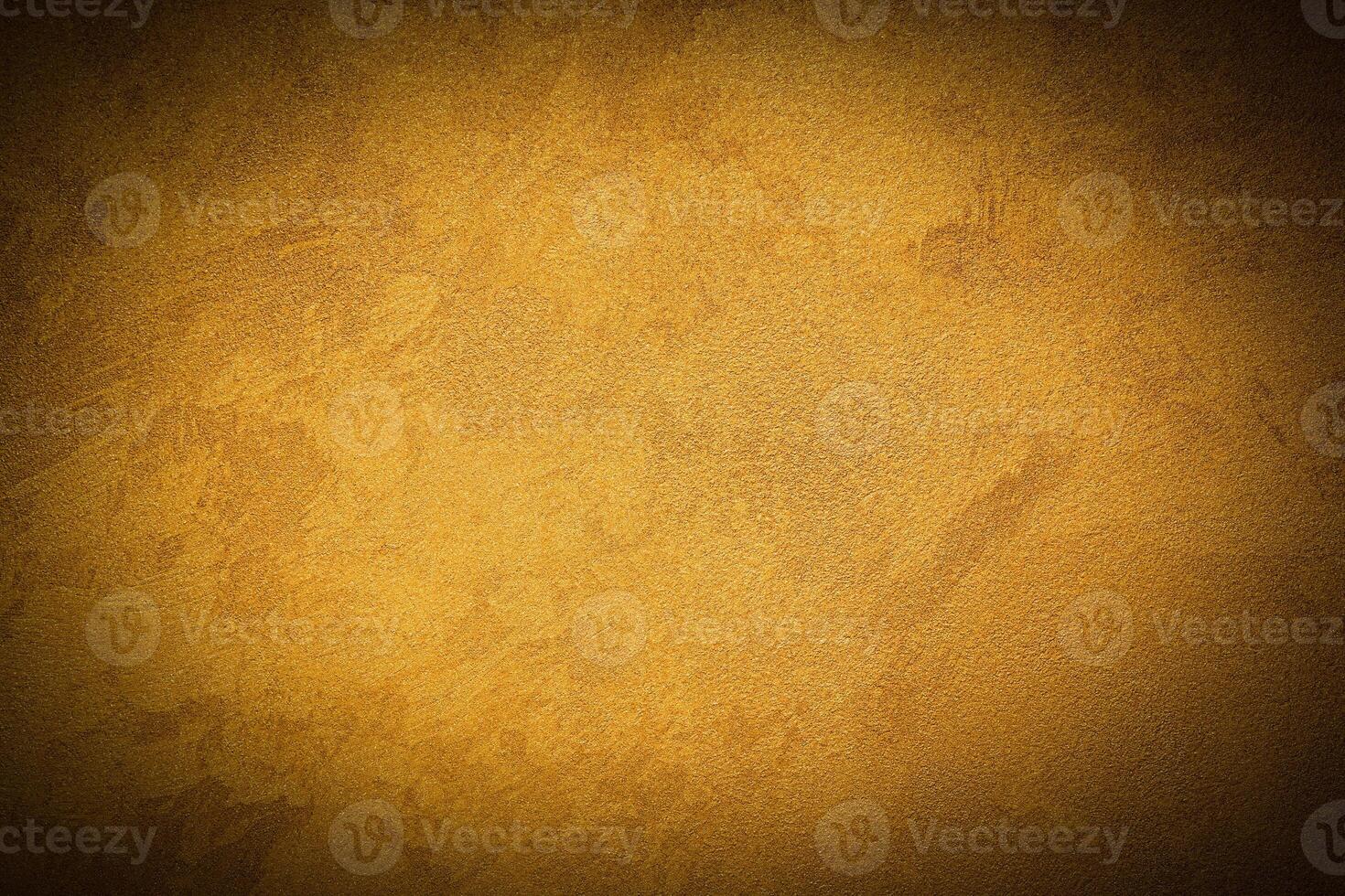 Texture of golden decorative plaster or concrete with vignette. photo