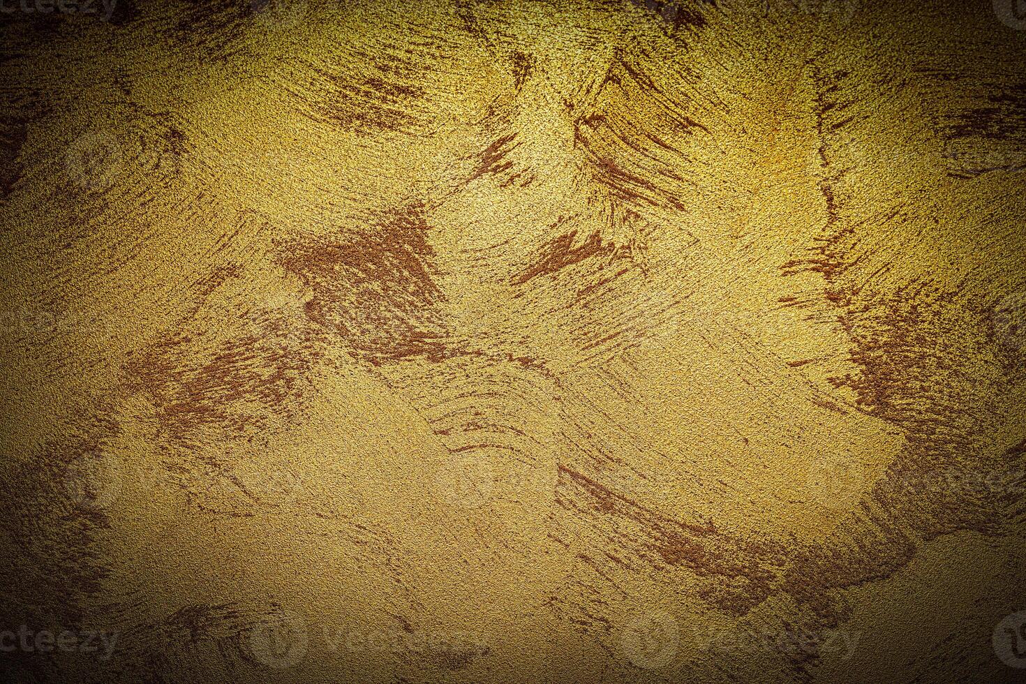 Texture of golden decorative plaster or concrete with vignette. photo