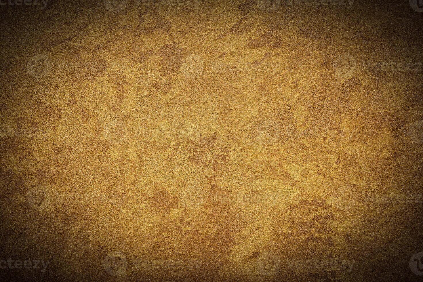 Texture of golden decorative plaster or concrete with vignette. photo