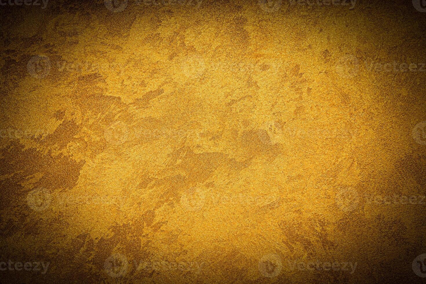 Texture of golden decorative plaster or concrete with vignette. photo