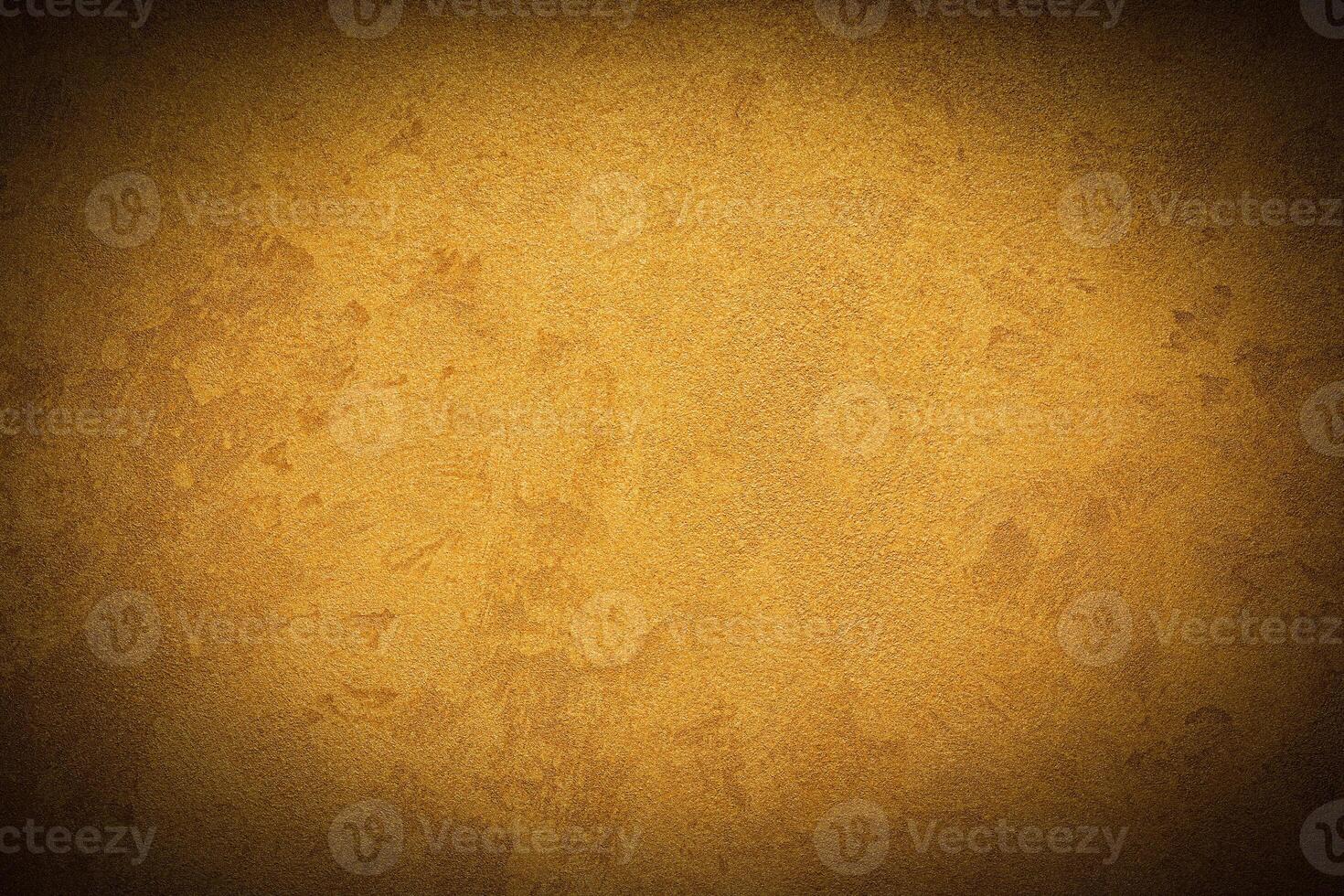 Texture of golden decorative plaster or concrete with vignette. photo