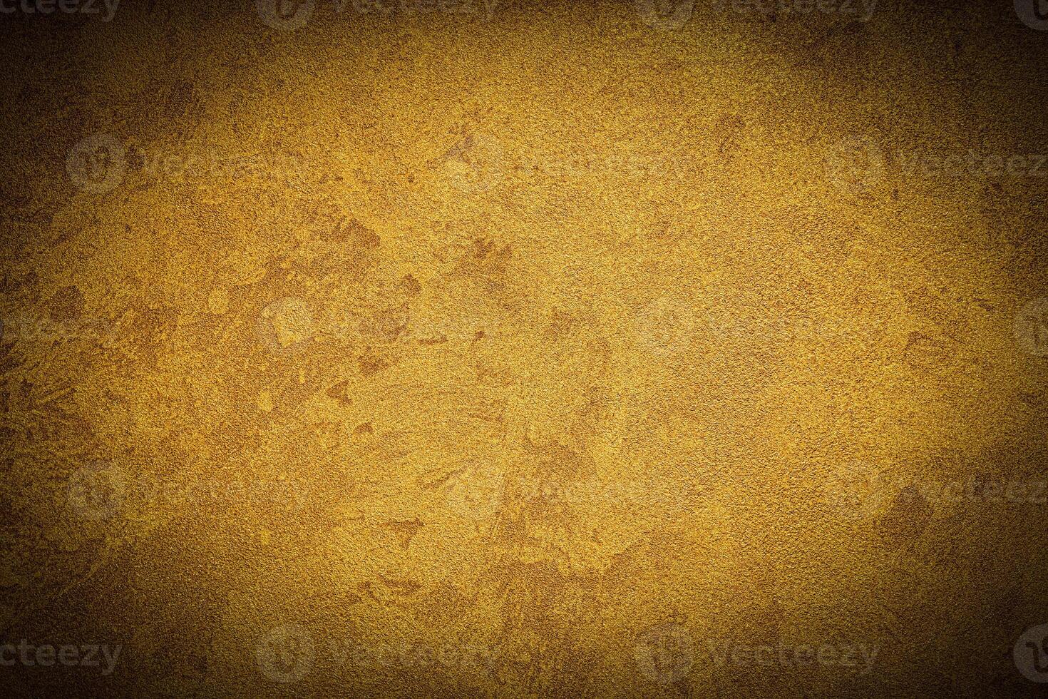Texture of golden decorative plaster or concrete with vignette. photo