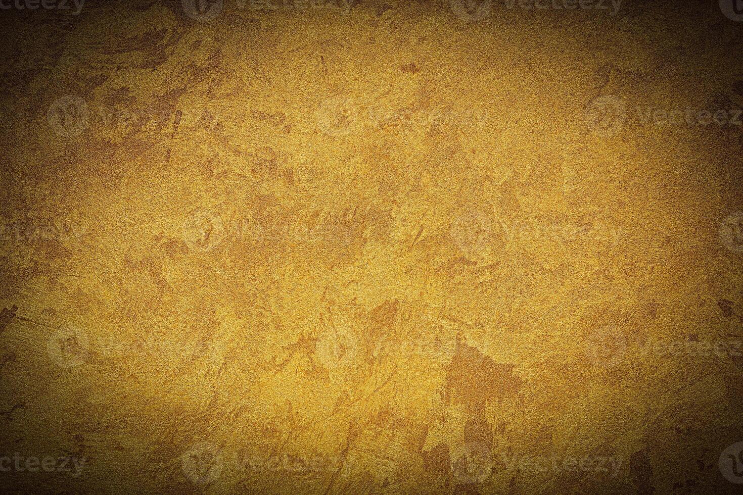 Texture of golden decorative plaster or concrete with vignette. photo