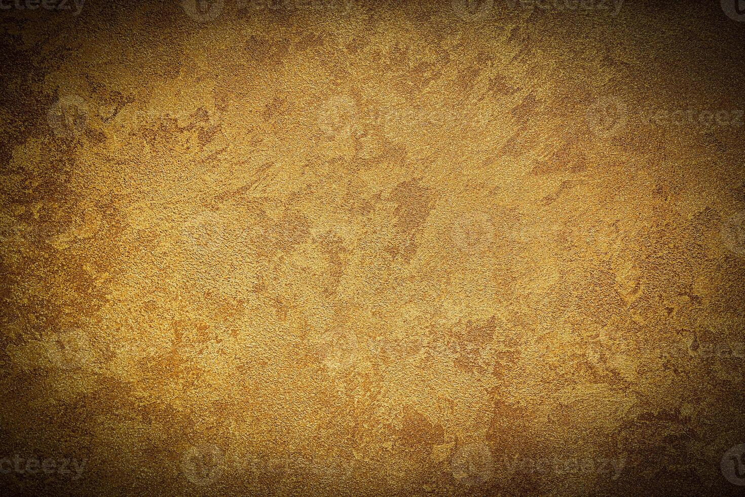 Texture of golden decorative plaster or concrete with vignette. photo
