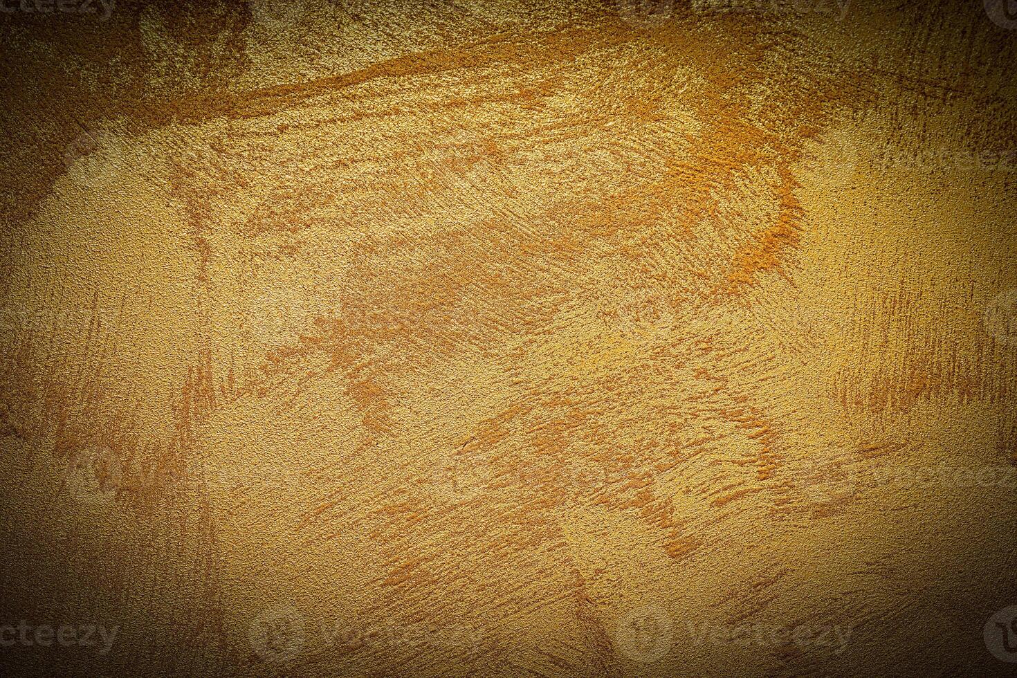 Texture of golden decorative plaster or concrete with vignette. photo