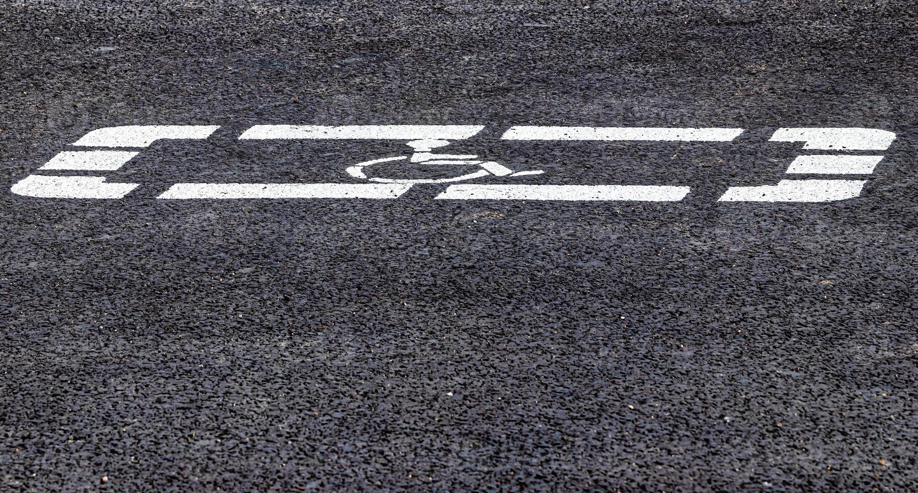 Parking lot with disabled parking sign on asphalt. Parking for a photo